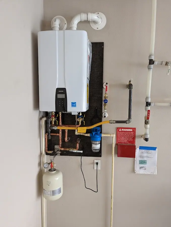 Professional plumber installing copper piping in a Palmer home